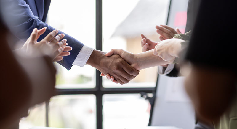 business people shaking hands closing a deal hubspot