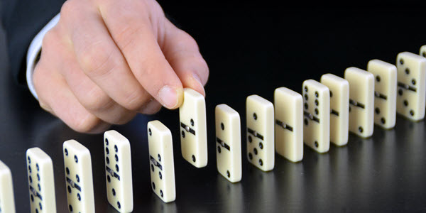 hand removing domino from line hubspot