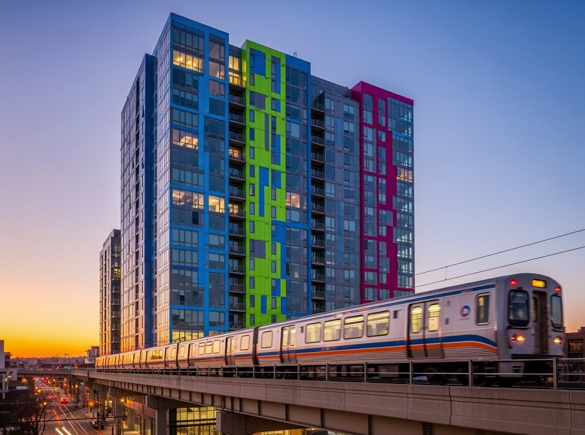 modern apartment building with commuter train