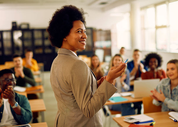 smiling teacher in classroom newsletter