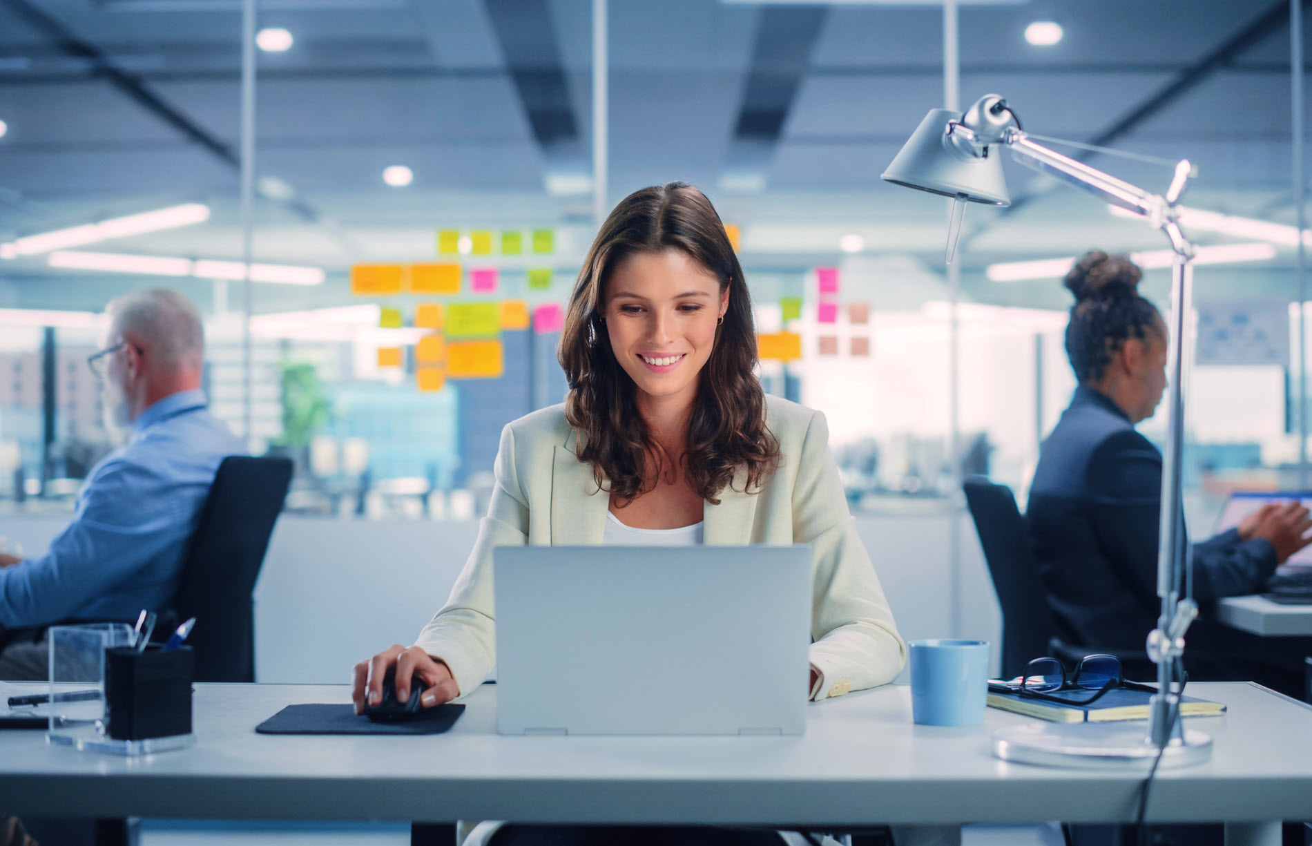 woman in office at laptop website